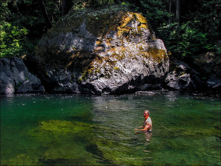 Chris Atkins explorer swimming in Redwood Creek on a measuring expedition