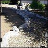 Ashland solution for  drainage and dry creekbed combination routed around water and rock in landscape